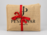 Gift wrapping: hessian bag tied with a red ribbon